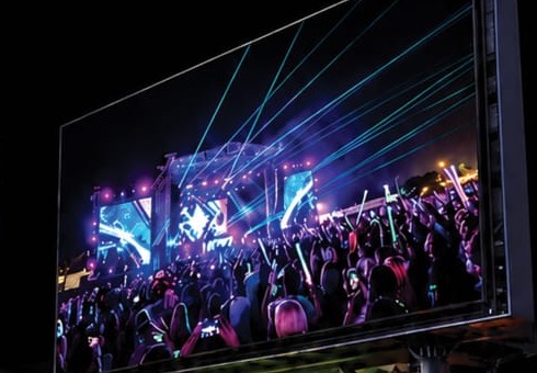Large outdoor LED video wall displaying a live concert